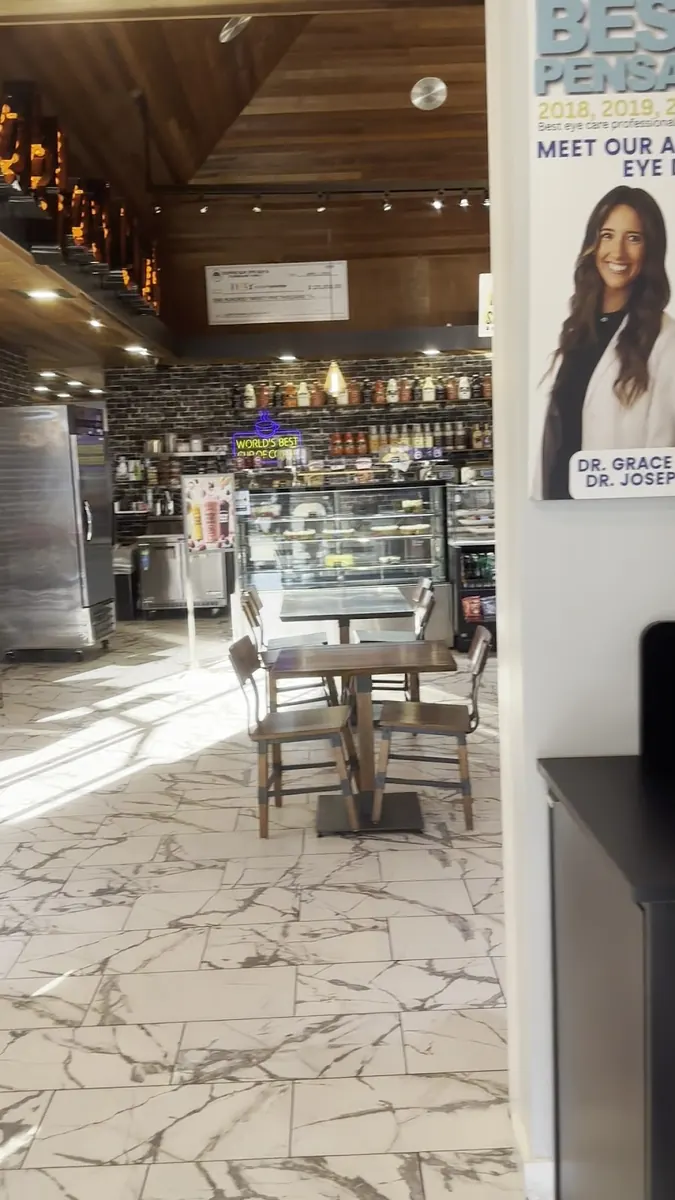 Inside The $50 Eye Guy at Coffee Guy Underground in Pensacola — cafe seating and the optometry counter